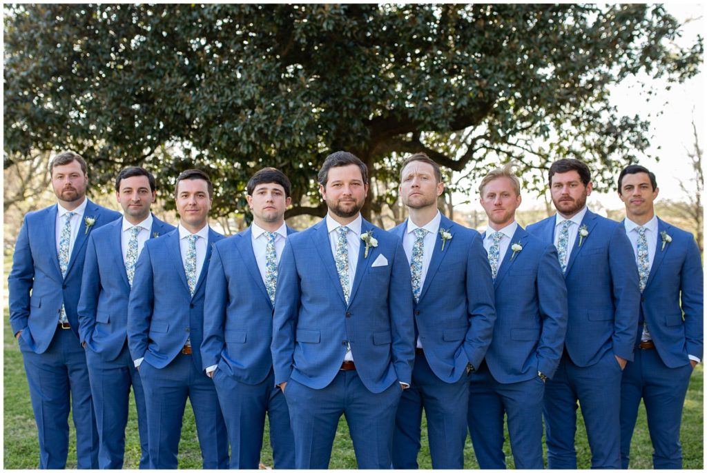 Groomsmen in navy suits and floral ties at riverwood mansion in nashville 