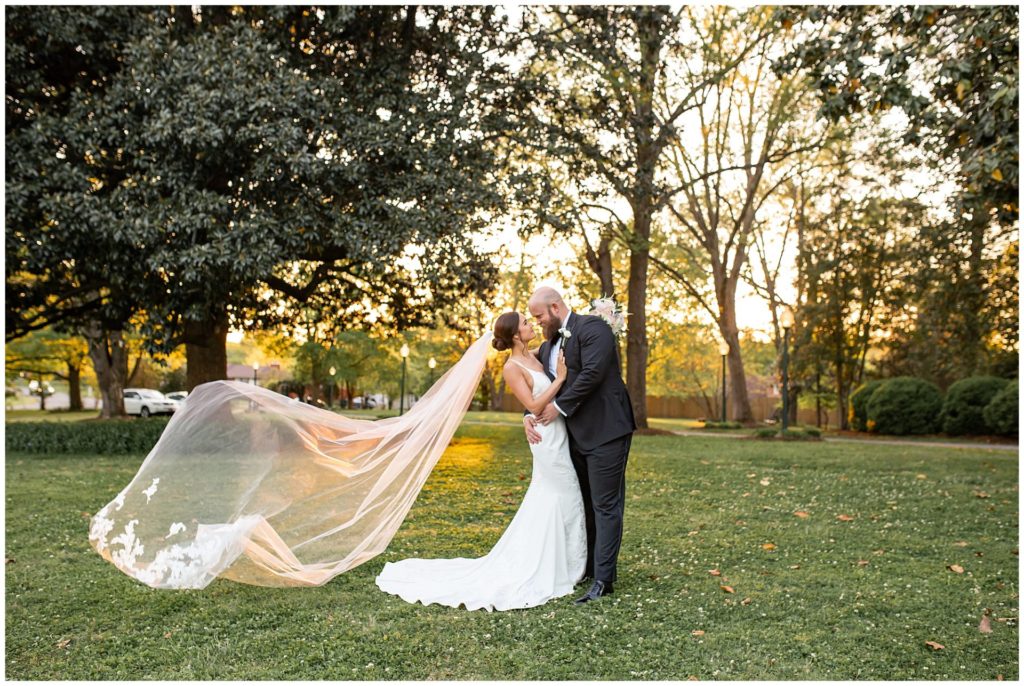 Bride and groom portraits at sunset with cathedral veil at Riverwood Mansion by top wedding photographer, Melanie Dunn
