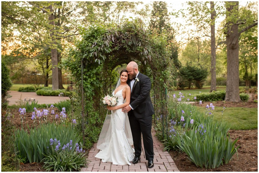 Bride and groom portraits in the ivy archway at Riverwood Mansion by top wedding photographer, Melanie Dunn