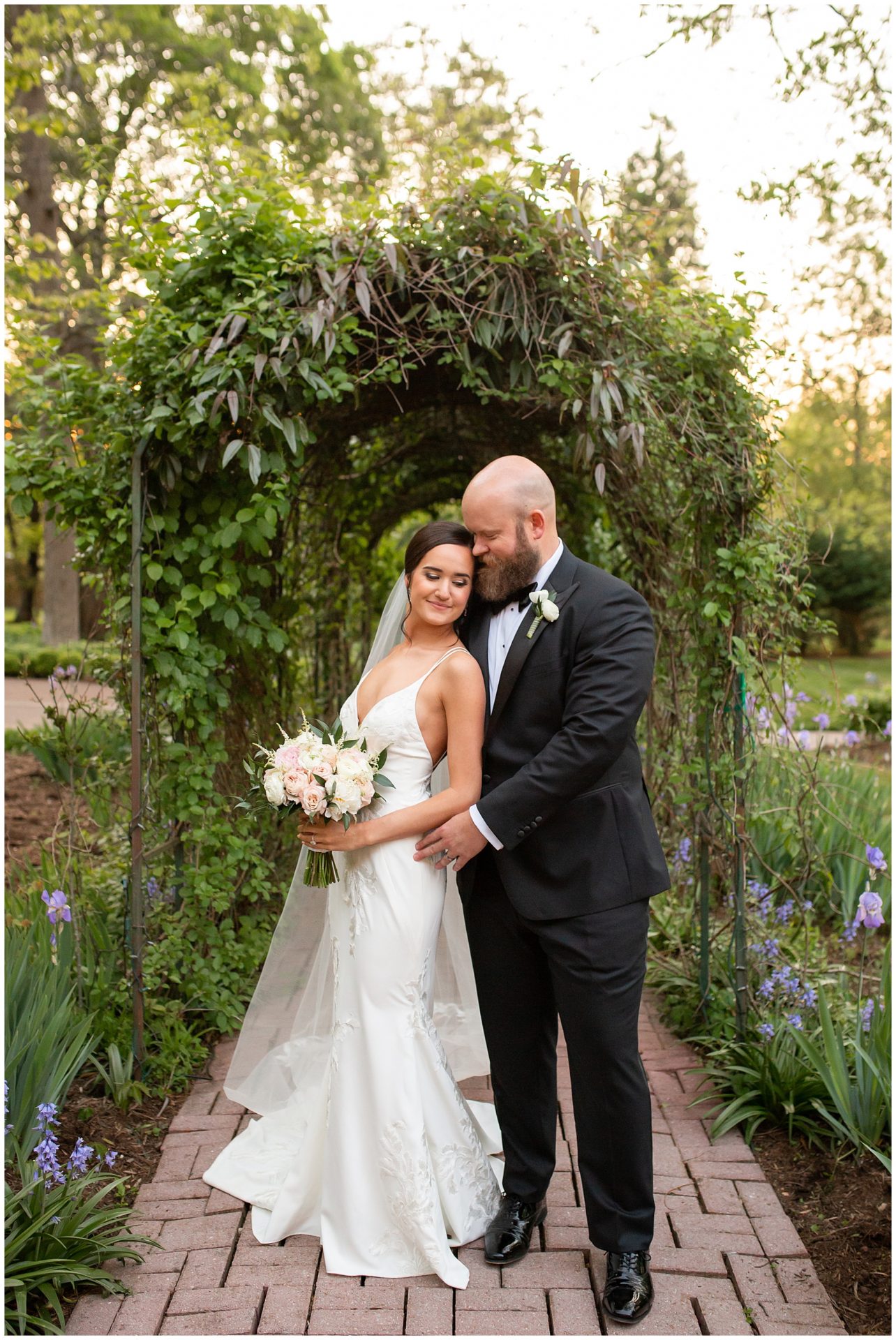 Bride and groom portraits in the ivy archway at Riverwood Mansion by top wedding photographer, Melanie Dunn